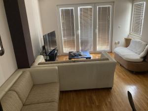 a living room with a couch and a table at SKY Apartments in Ohrid