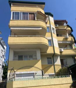a tall building with a fence in front of it at SKY Apartments in Ohrid