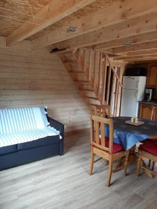 a living room with a table and a bed and a kitchen at La Roselière cottage at Lake Laffrey with parking in Laffrey