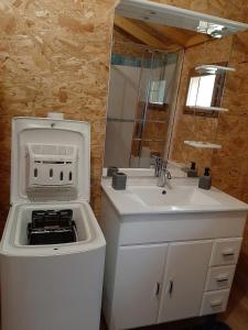 a kitchen with a sink and a stove and a sink at La Roselière cottage at Lake Laffrey with parking in Laffrey
