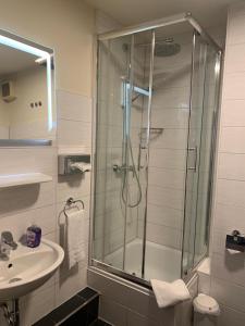 un baño con ducha y lavabo en Hotel an der Hörn, en Kiel 19 fotos más