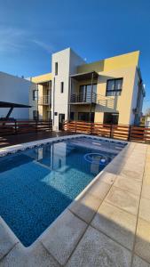 a house with a swimming pool in front of a house at MONACO Departamento PA in Federación