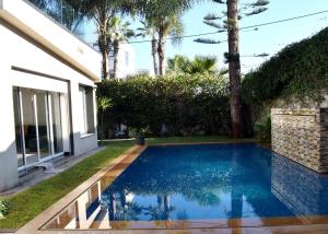 a swimming pool in the backyard of a house at Villa Les Ambassades in Kenitra