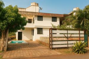 a house with a fence in front of it at ll MOCKTAIL VILLA ll AC ll PRIATE POOL ll in Lonavala