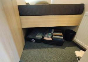 a suitcase is sitting under a bunk bed at Sho inn MINIMAL HOTEL 小樽駅から無料送迎あり in Otaru +25 photos