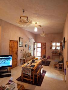 a living room with a table and a tv at El-Beit in Siwa +34 photos