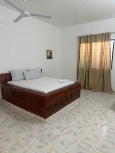 桑给巴尔Spice Garden Lodge B&B的配有吊扇的客房内的一张床位