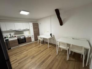 a kitchen and dining room with white tables and chairs at Monteurzimmer Renix Heilbronn in Brackenheim +9 photos