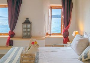a bedroom with a bed with a view of the ocean at Sea Frame in Skiathos