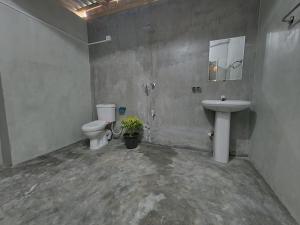 a bathroom with a toilet and a sink at Ryo hostel in Ahangama +19 photos