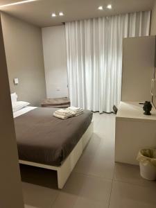 Un dormitorio con una cama con toallas. en NINFEA sweethome, en Foggia