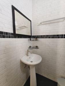 a white bathroom with a sink and a mirror at Bua sawan poolvilla kohlanta in Ban Not (1) +34 photos
