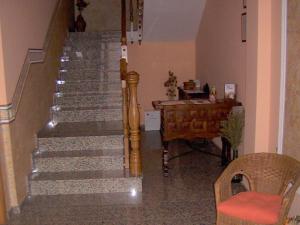 a room with stairs and a table and a desk at Villa de La Yunta in La Yunta