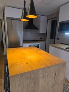 a kitchen with a wooden counter top in a kitchen at Sweet Dreams Olivares in Talavera de la Reina +2 photos