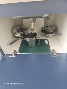 a stove top with a pot and pans on it at Studio | Expo Stay Tucuruvi Metro |Swimming pool in São Paulo