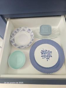 a set of plates and plates on a shelf at Studio | Expo Stay Tucuruvi Metro |Swimming pool in São Paulo +27 photos