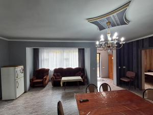 a living room with a table and a couch at Campfire guesthouse in Dilijan