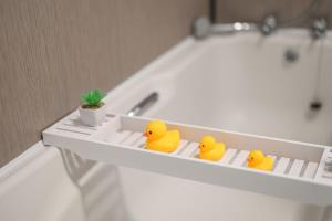 three rubber ducks sitting on a shelf in a bath tub at Entire Home- Parking - Fibre Broadband - Air Fryer - Big TV - 4 bedrooms - 8 guests in Elswick +47 photos