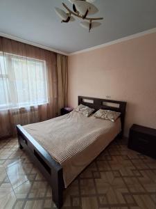 a bedroom with a bed and a ceiling fan at Campfire guesthouse in Dilijan