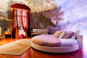 a bedroom with a bed with a painting on the wall at Villa Meraville B&B in Bologna
