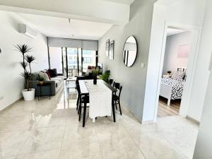 a dining room and living room with a table and chairs at Bright & cozy apartment in Livadia in Livadhia
