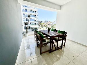 a dining room with a table and chairs on a balcony at Bright & cozy apartment in Livadia in Livadhia
