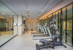 a gym with several treadmills and elliptical machines at Btwins Pinamar in Pinamar