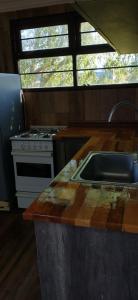 a kitchen with a stove and a sink at Casa Nina in Camet Norte +11 photos