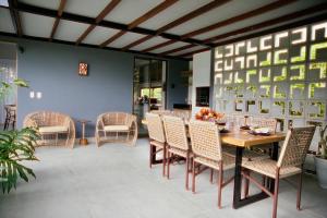 a dining room with a table and chairs at Villa Egeu Praia da Pipa in Pipa +64 photos