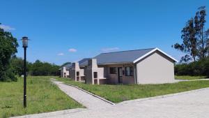 a row of houses on the side of a road at Mthontsi Lodge in Kroomie