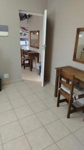 a room with a table and a mirror and a table at Mthontsi Lodge in Kroomie