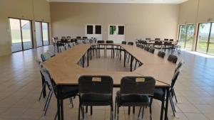 a large conference room with a large table and chairs at Mthontsi Lodge in Kroomie +17 photos