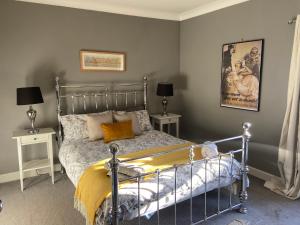 a bedroom with a bed with two tables and two lamps at The City Pad in Norwich