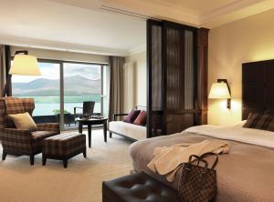 a hotel room with a bed and a view of the ocean at The Europe Hotel & Resort in Killarney
