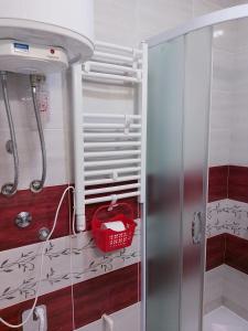 a refrigerator in a kitchen with a red basket at Studio La Casa in Soko Banja