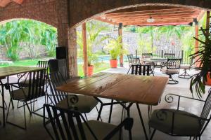 a restaurant with tables and chairs and a patio at Hotel Boutique Canto De Piedra in Tamasopo