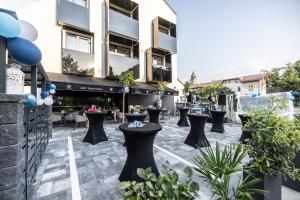 a patio with tables and chairs in front of a building at G&T Square Apartments in Liptovský Mikuláš