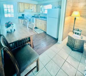 a kitchen with a table and a refrigerator at Smoky Mountain Cabin with HOTTUB in Seymour