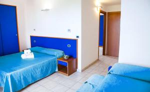 En eller flere senge i et værelse på Hotel Smeraldo