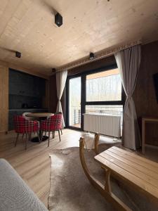 a living room with a couch and a table at Apartmán Forest, Tatranská Štrba in Tatranska Strba
