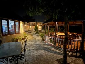 patio ze stołem i krzesłami w nocy w obiekcie Jungle Safari Resort w mieście Sauraha