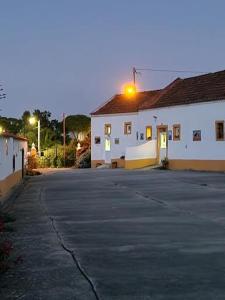 an empty parking lot in front of a white building at Casa Fernando Casquinha in Vila Franca de Xira