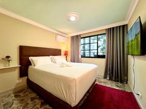 a bedroom with a bed and a large window at DUO BOUTIQUE HOTEL in Medellín +132 photos