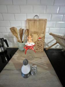a kitchen counter with wooden utensils on a counter top at Appartement cosy dans le centre historique de Vence in Vence