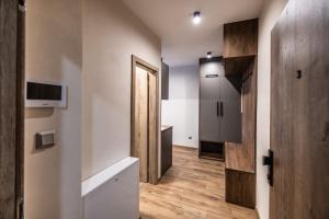 a room with a hallway with a door and a kitchen at G&T Square Apartments in Liptovský Mikuláš +39 photos