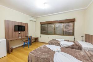 Postel nebo postele na pokoji v ubytování Hotel Letto Caxias