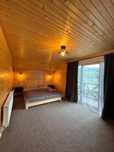 a large room with a bed and a window at Фазенда in Vorokhta