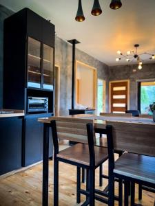 a kitchen with a wooden table and chairs in a kitchen at Refugio Nauru in Puerto Dunn