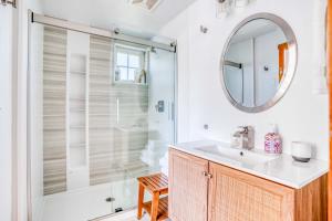 a bathroom with a shower and a sink and a mirror at Sunshine and Sweaters in Pacific City +39 photos