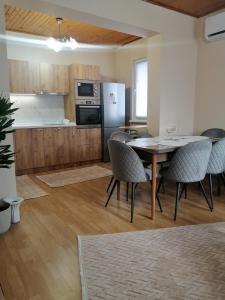a kitchen and dining room with a table and chairs at Уют in Haskovo